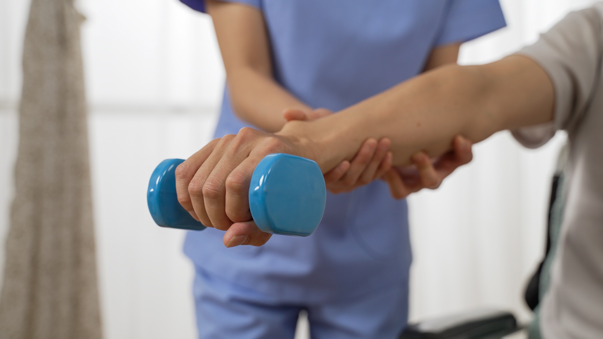 senior goes through rehab training using dumbbell